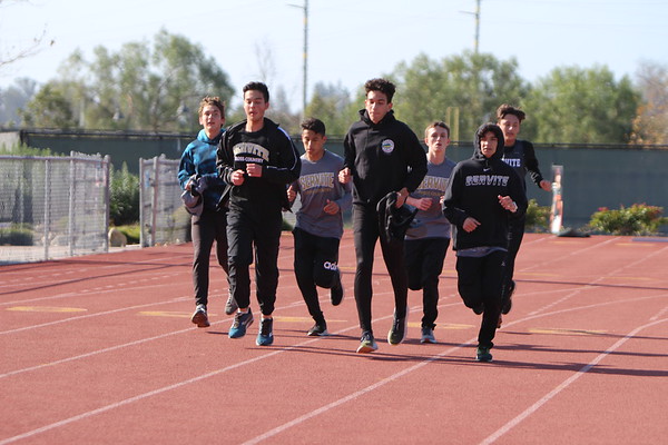 Servite Cross Country team running warm up laps before their race.