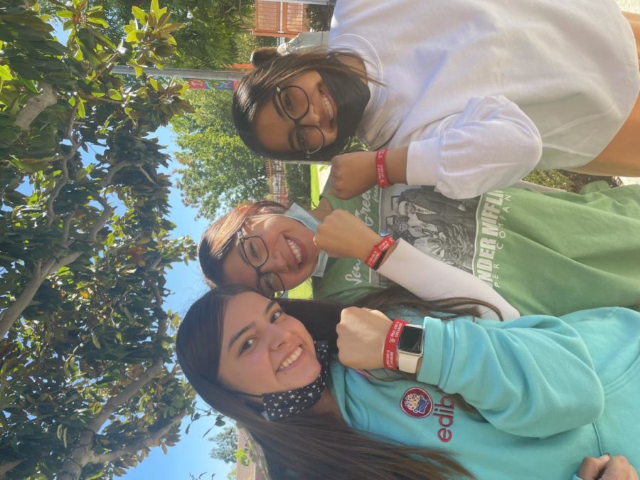 Seniors Elena Navarro, Alinna Rivera, and Iliana Macias pose with their red bracelets to support no drug abuse.

