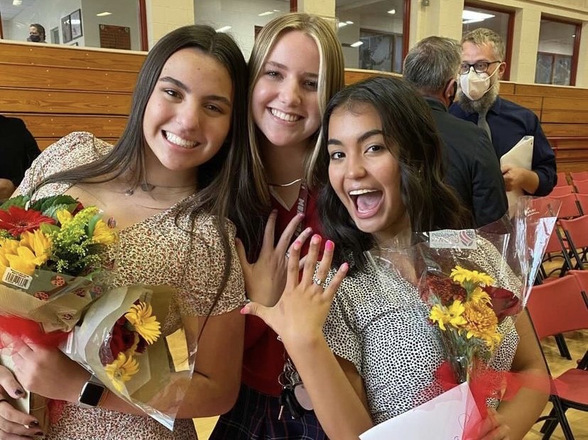 Juniors Emma Silva and Adriana Arroyo show off their rings and flowers with senior Abby Tice after the ceremony. Photo provided by Adriana Arroyo.