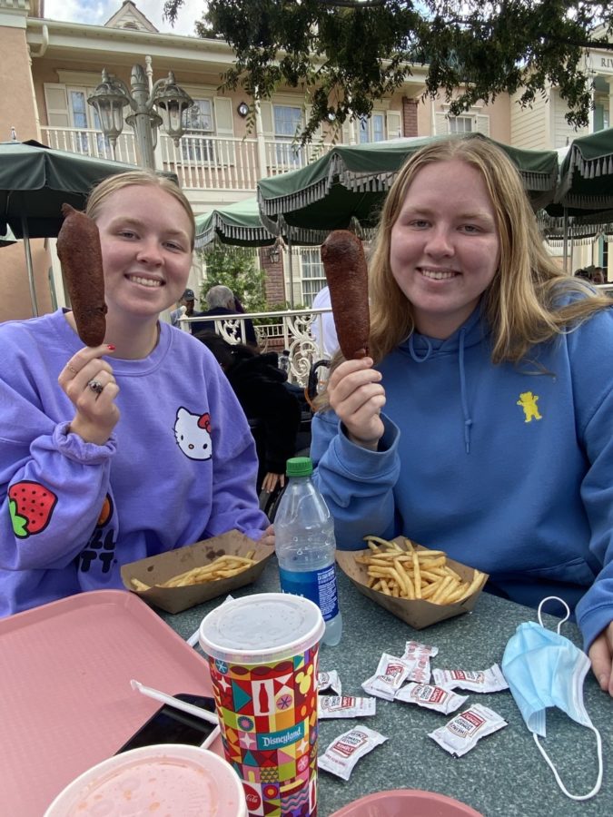 Anna and Charlotte are all smiles with their Disney corn dogs in hand.