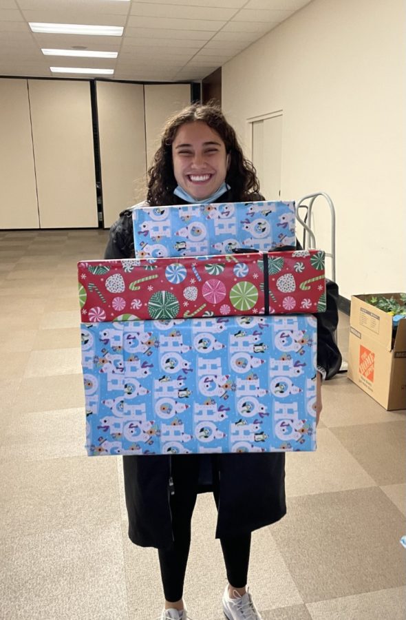 Senior Gabriella Cardenas is holding a few of the gifts that will be donated. 