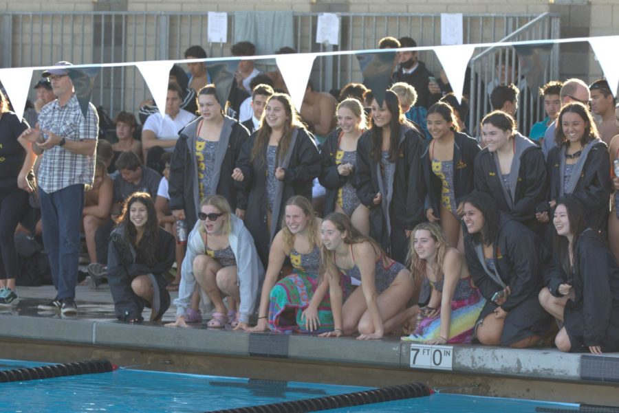 The team cheers as Elizabeth Harita 22 approaches the wall on the second lap of her 200 meter Individual Medley race.