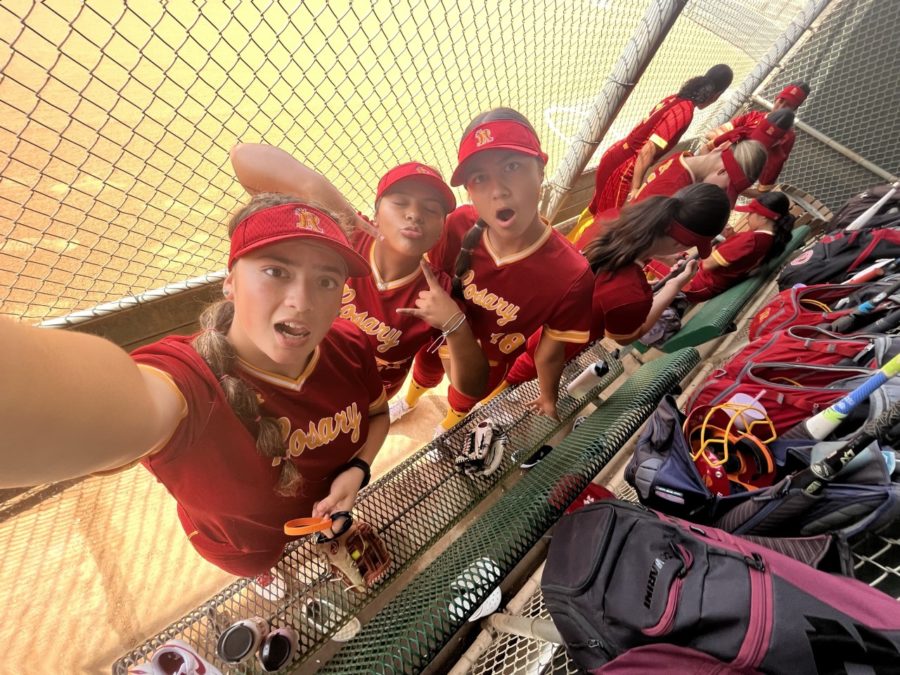 Here members of the softball team enjoy spending time together in the dugout during their game last Friday. (Photo Provided by Melissa Hanson)