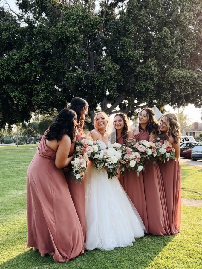 Mrs. Vasquez with all of her bridesmaids on her wedding day.