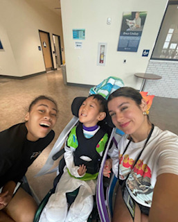 Senior Cadiz Salazar with her co-counselor and her camper. Look at his wonderful Buzz-Lightyear costume!