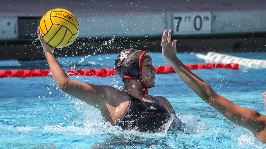 An action shot of a Royal shooting a goal during the water polo game. 