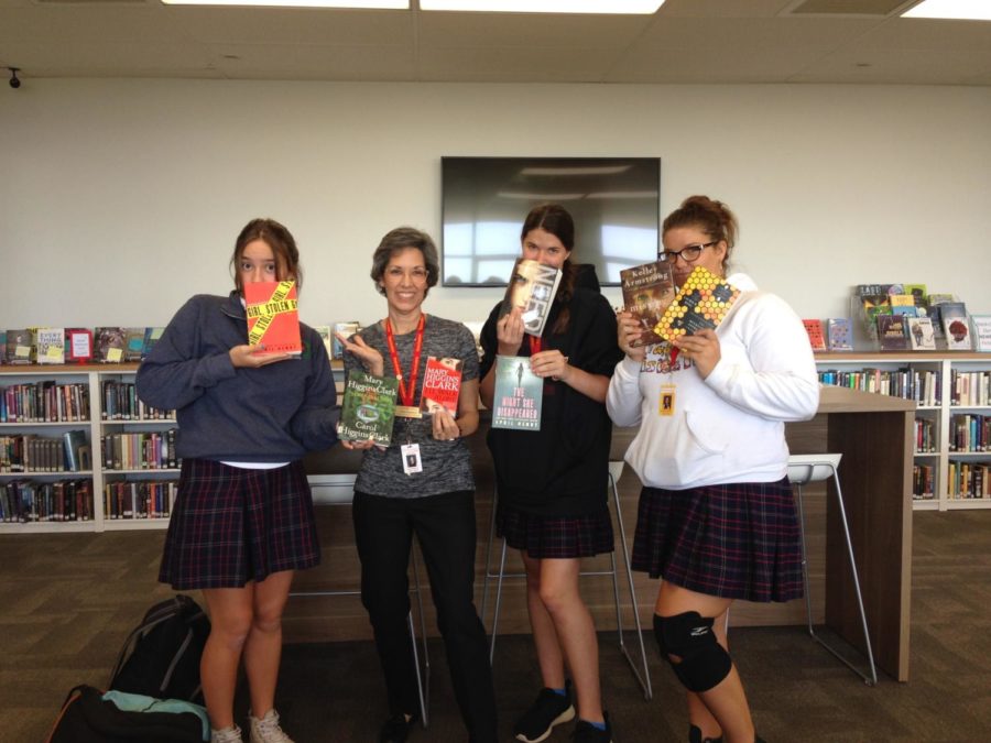  Book Club Officers showing their favorite Mystery/Crime novels. (Photo Provided by Mrs. Roberts)