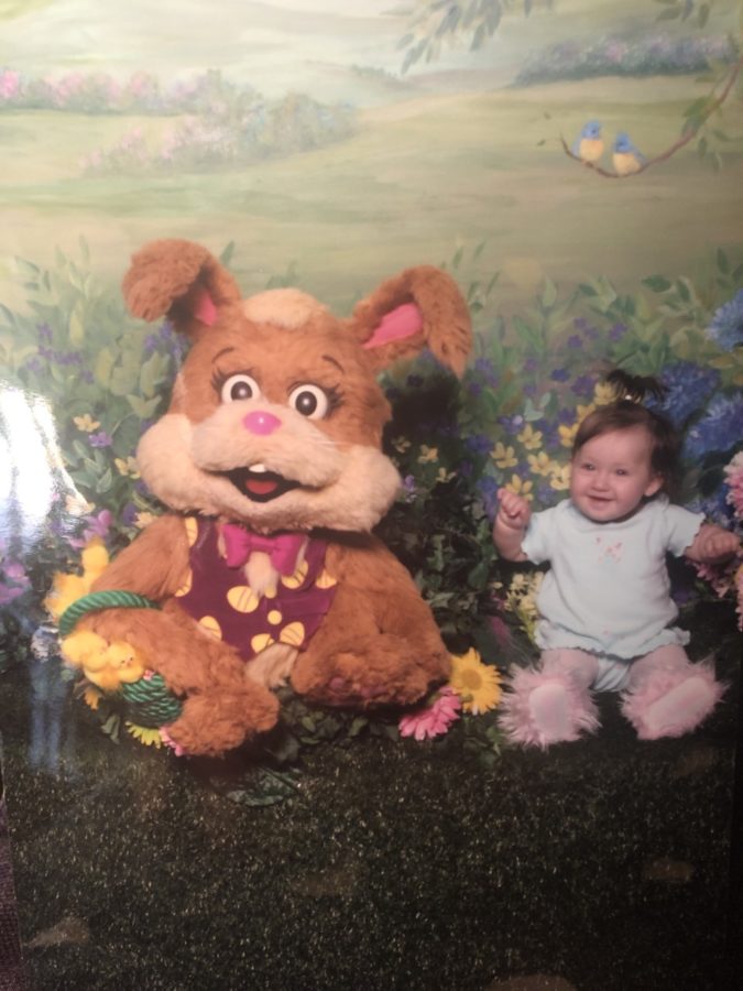 Tiny Christina Vaughan '26 breaks out in a smile beside the Easter bunny.