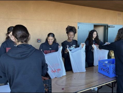 The Rosary Basketball team volunteered at a food distribution center last semester. (Photo taken from @Rosaryroyals Instagram)