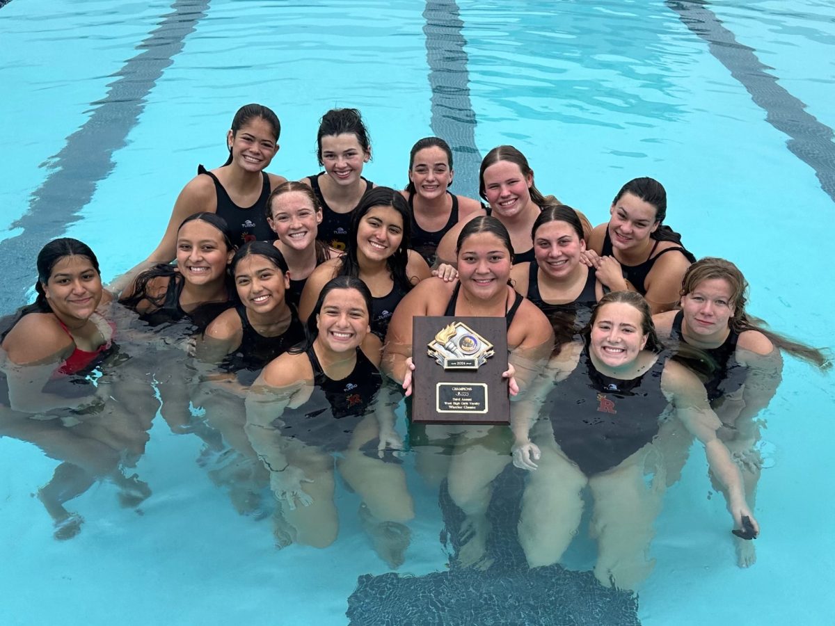 The water polo team holds their first-place plaque after winning all four games in the tournament.
