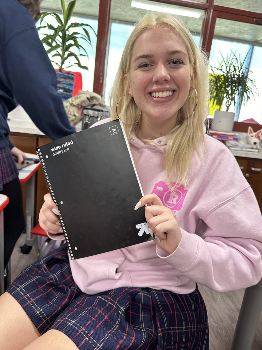 Cait Smith 24 holds onto her notebook with pride.