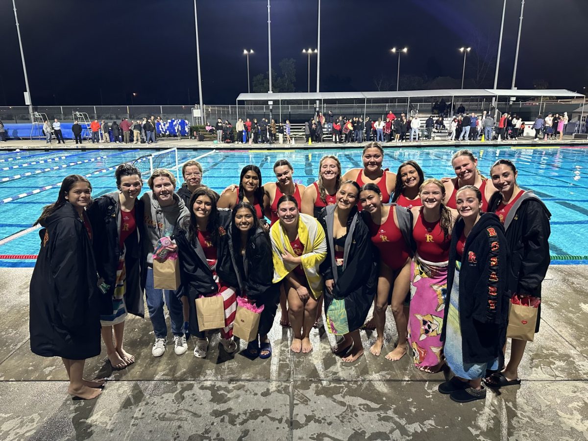 The Rosary water polo team smiles for a picture after winning the semi-final game. 