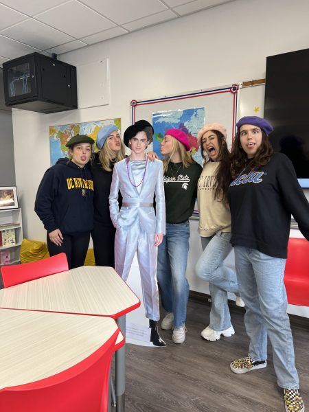 AP French poses with a cardboard cutout of Timothee Chalamet