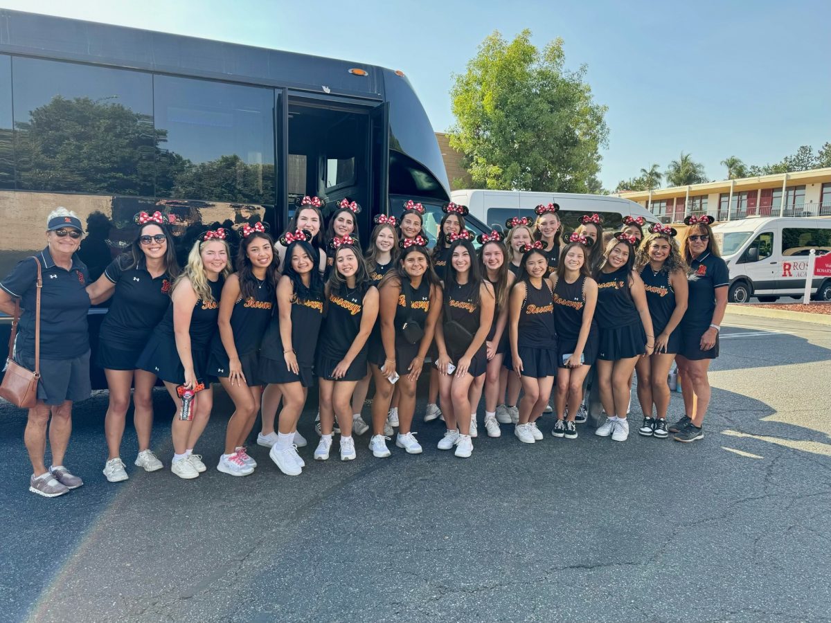 The tennis team snaps a picture in front of the party bus!