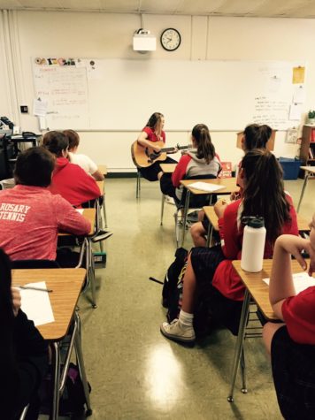 Kat Davis plays an original song for a freshman English class. 