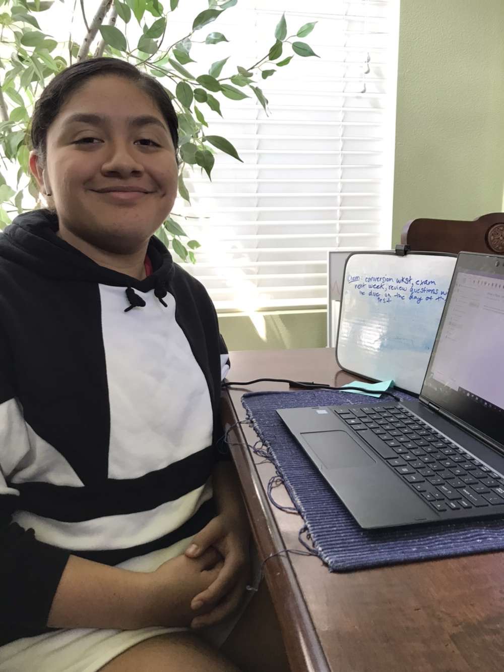 Samantha Guerrero is all smiles while showcasing her desk and whiteboard.