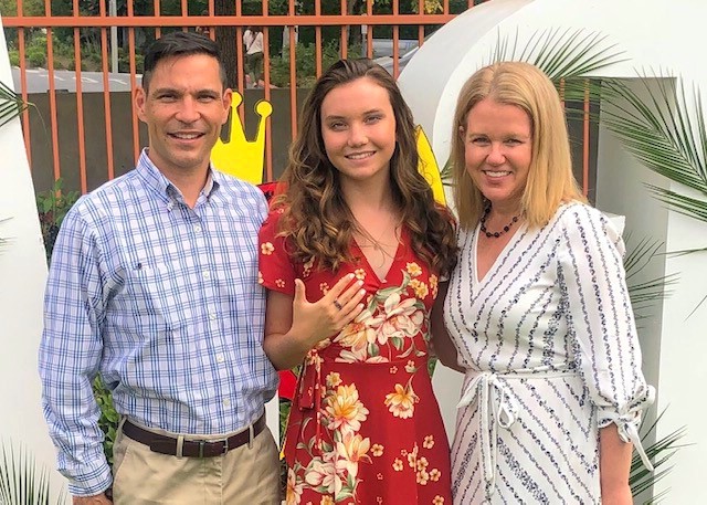 Junior Elizabeth Harita with her parents including her alumna mom, Jennifer.