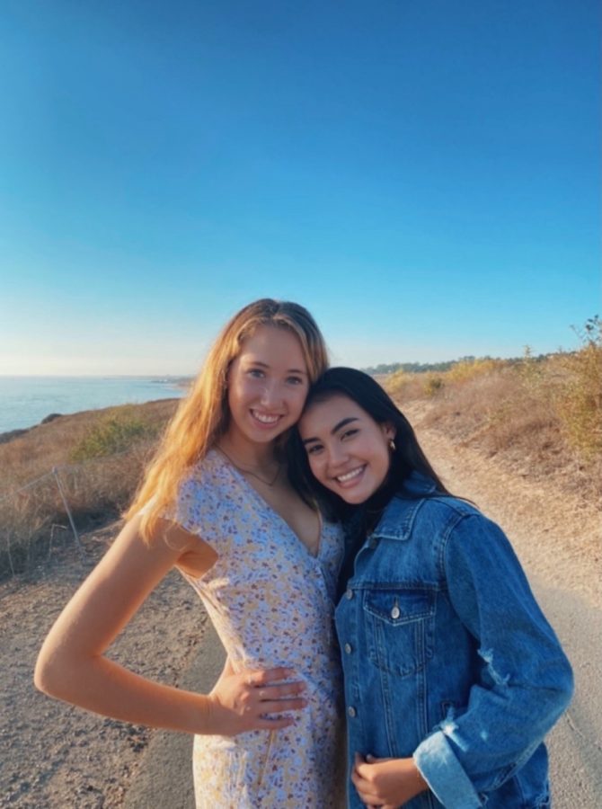 Adriana Arroyo' 23 and Elena Walz' 22 smiling for a picture at the beach.