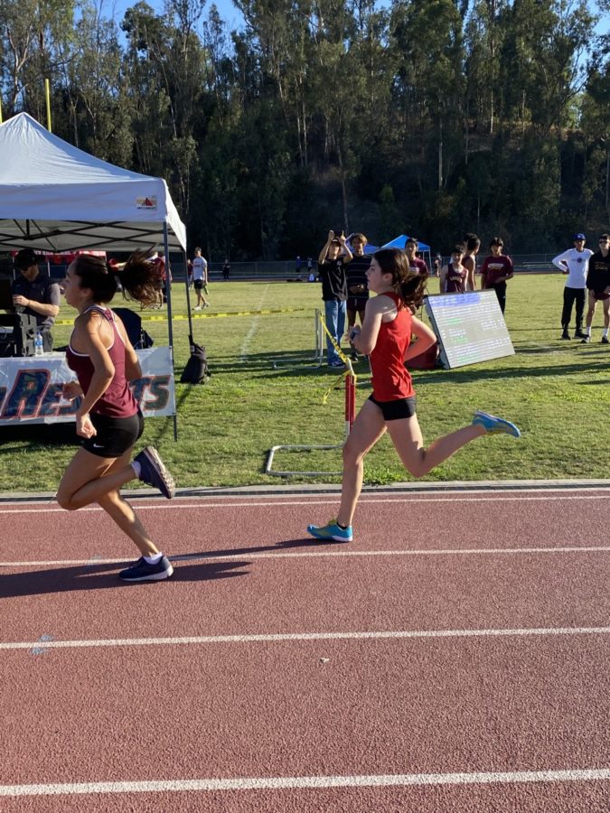 Sophia Long sprinting the last 100 meters of the race.