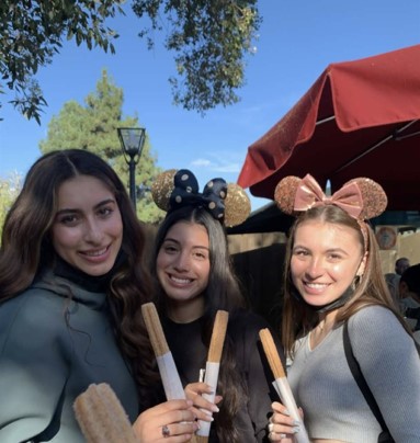 Nicole snaps a picture of her friends enjoying their classic Disney churro's.