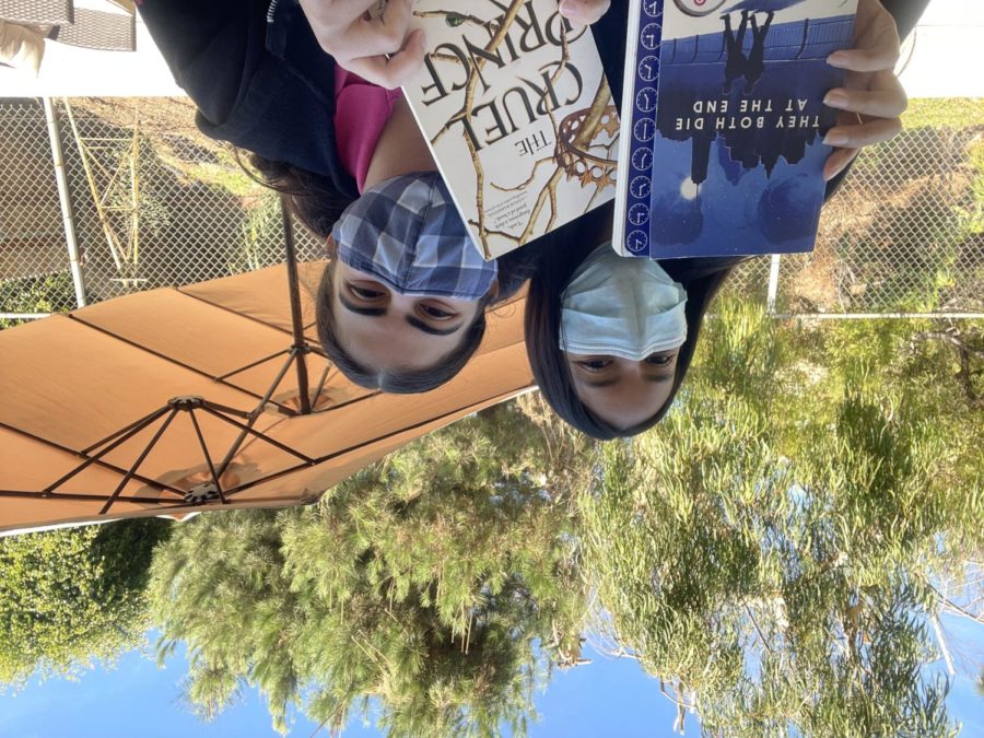 Irene Fernandez '22 and Mary Nassar '22 pose with "They Both Die at the End" and "The Cruel Prince."