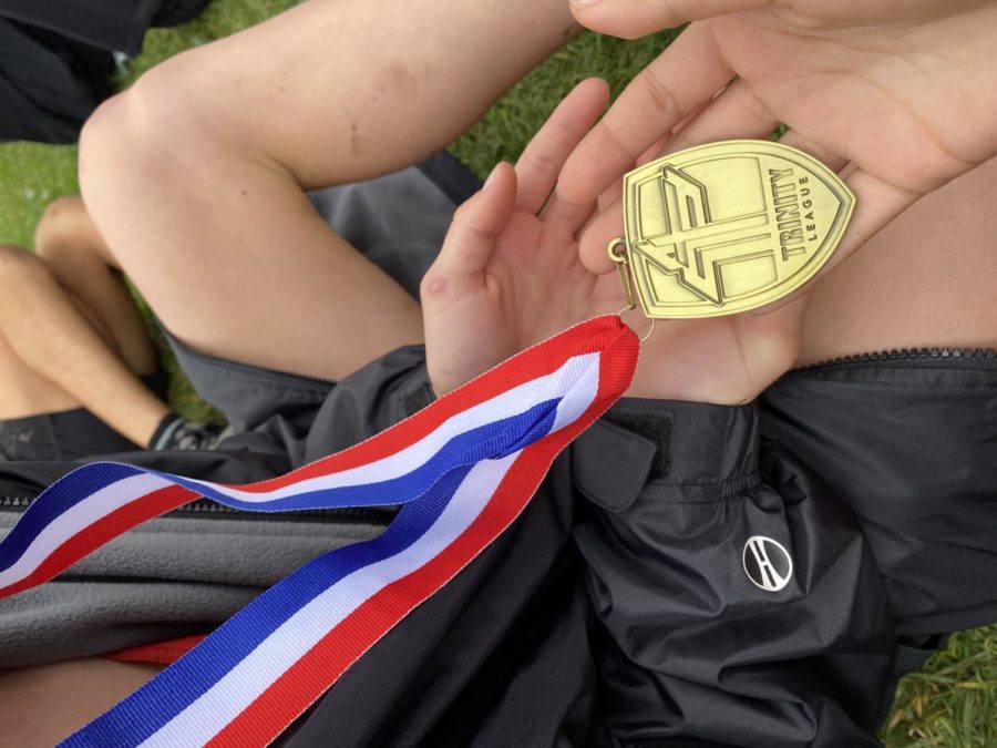 Sophia Long '24 holds her medal for getting 19th place in the varsity race.