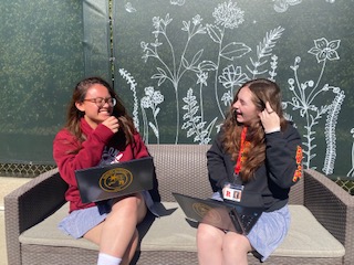 Skylar Cooper '22 and Chelsea Bartilad '22 laughing with eachother during their time in journalism.