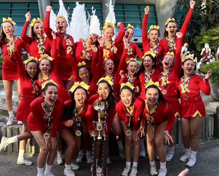 The cheer team screams with joy in honor of their two big wins.