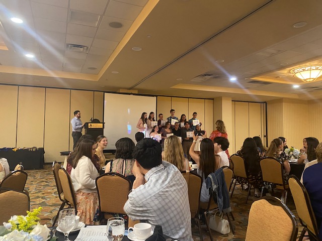 Students get together for a group picture after proudly receiving their awards.