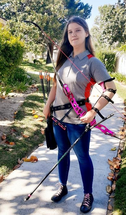 Kiera smiles as she proudly holds her personalized bow. (Photo Provided by Kiera Bush)