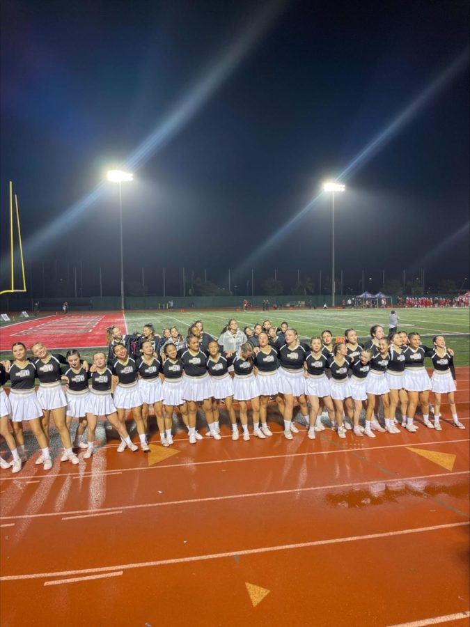 The Rosary Dance and Cheer Team making the most out of their night cheering in the rain. 
