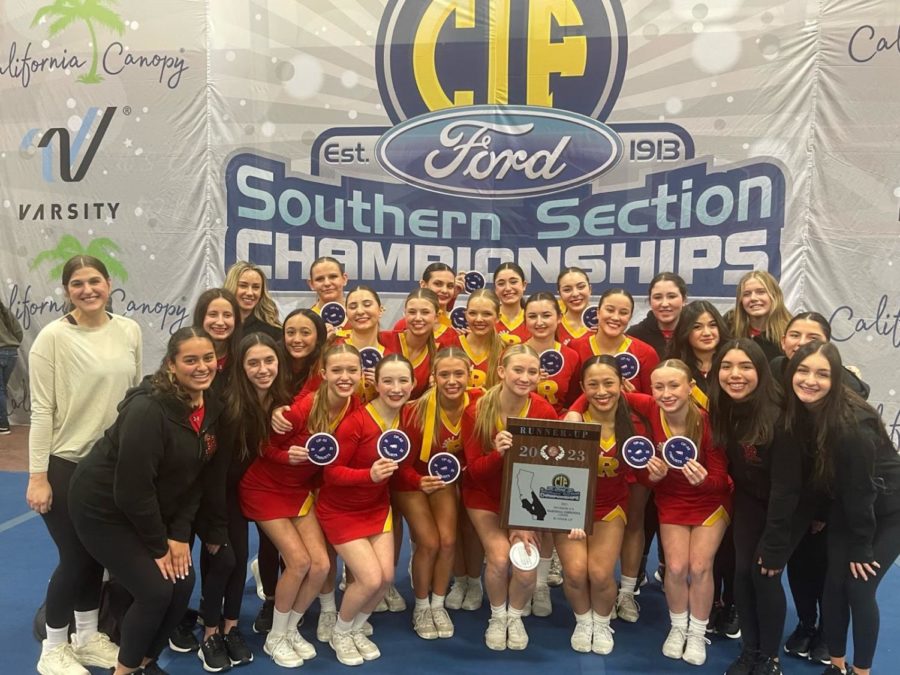 The cheer team poses with their new plaque after securing a second place spot at CIF. (Photo provided by Tori Gomez '23).