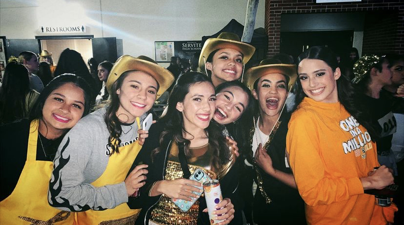 From left to right: McKinley Fregoso '24, Ava Bernard '24, Amber Lizardi '23, Samara DeLeon '23, Emma Oskorus '23, Adrianna Arroyo '23, Emma Vasquez '23. These girls were all smiles after performing their best during last year's Red and Gold performance (something a Servite boy will never understand). 
