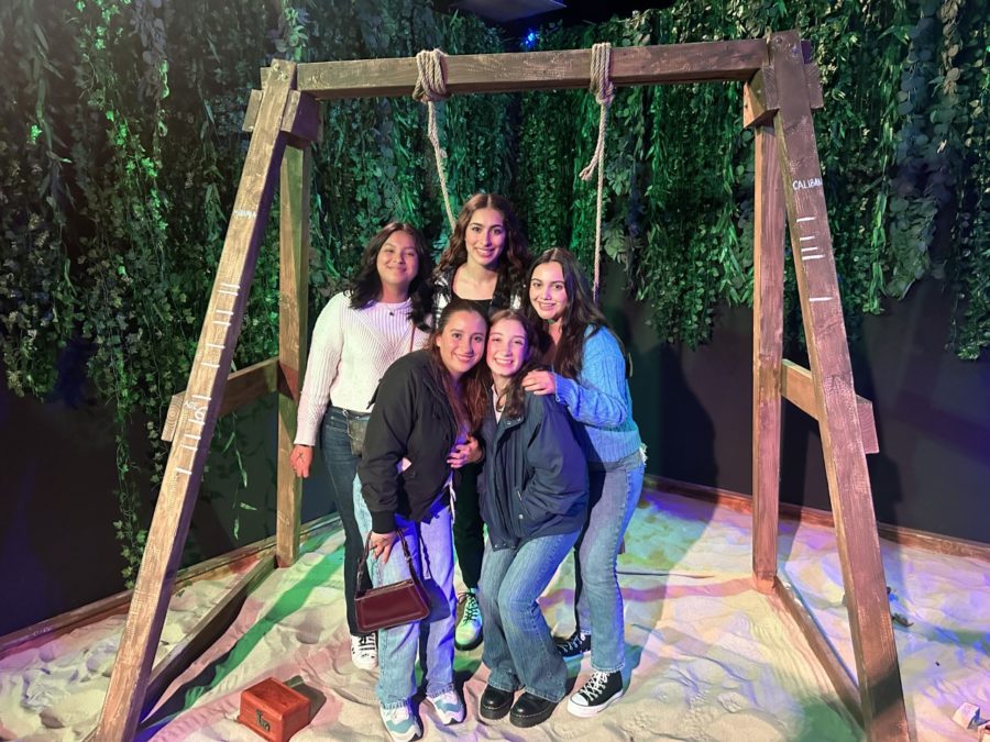 The class snaps a picture in front of Caliban's childhood sand box.