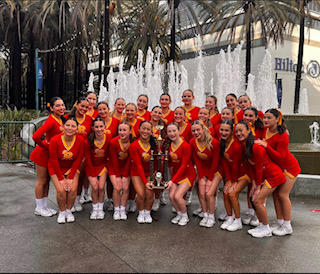 Check out the cheer team with their huge trophy! (Photo provided by the Rosary Cheer Team's Instagram)