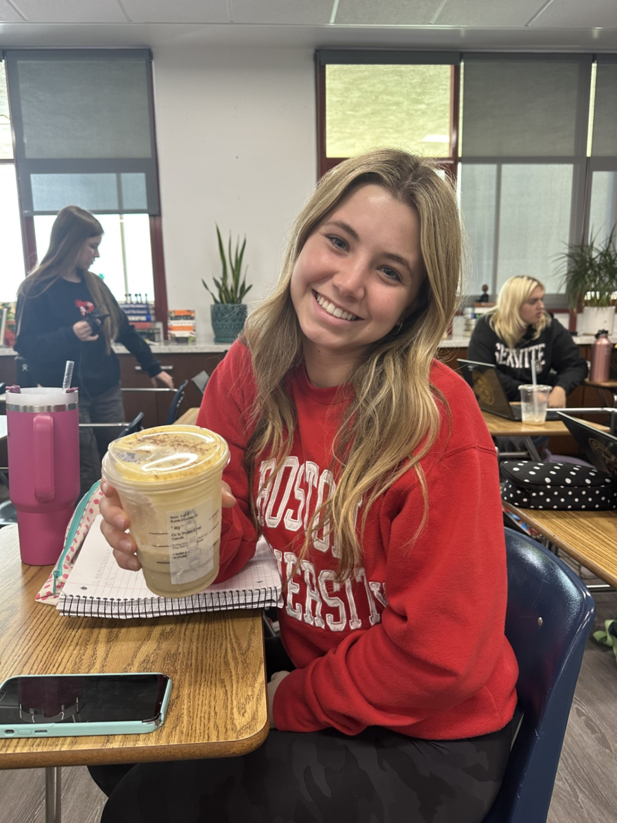 Lily Curtis '24 enjoying her delicious Iced Pumpkin Cream Chai Latte.