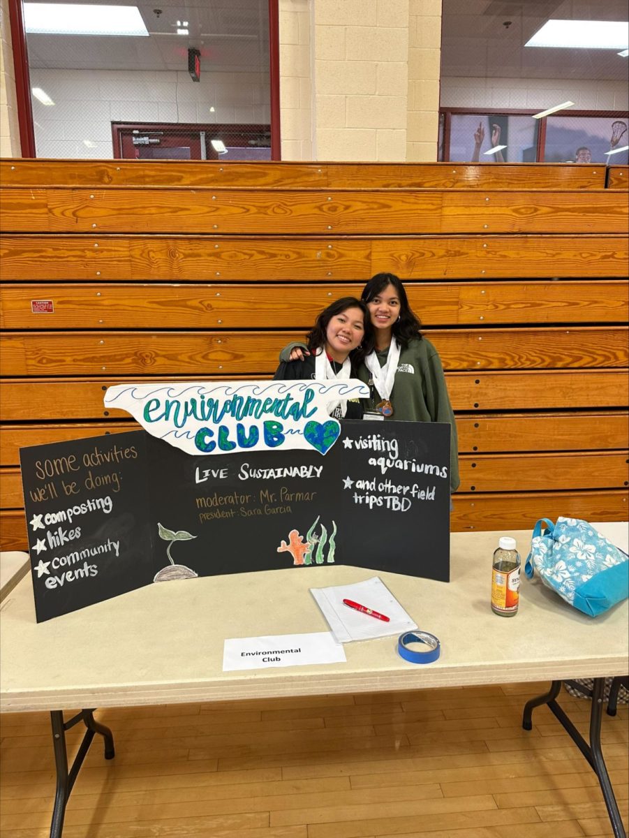 Sara Garcia '24 and Althea Arazo '24 pose to display the Environmental Club
