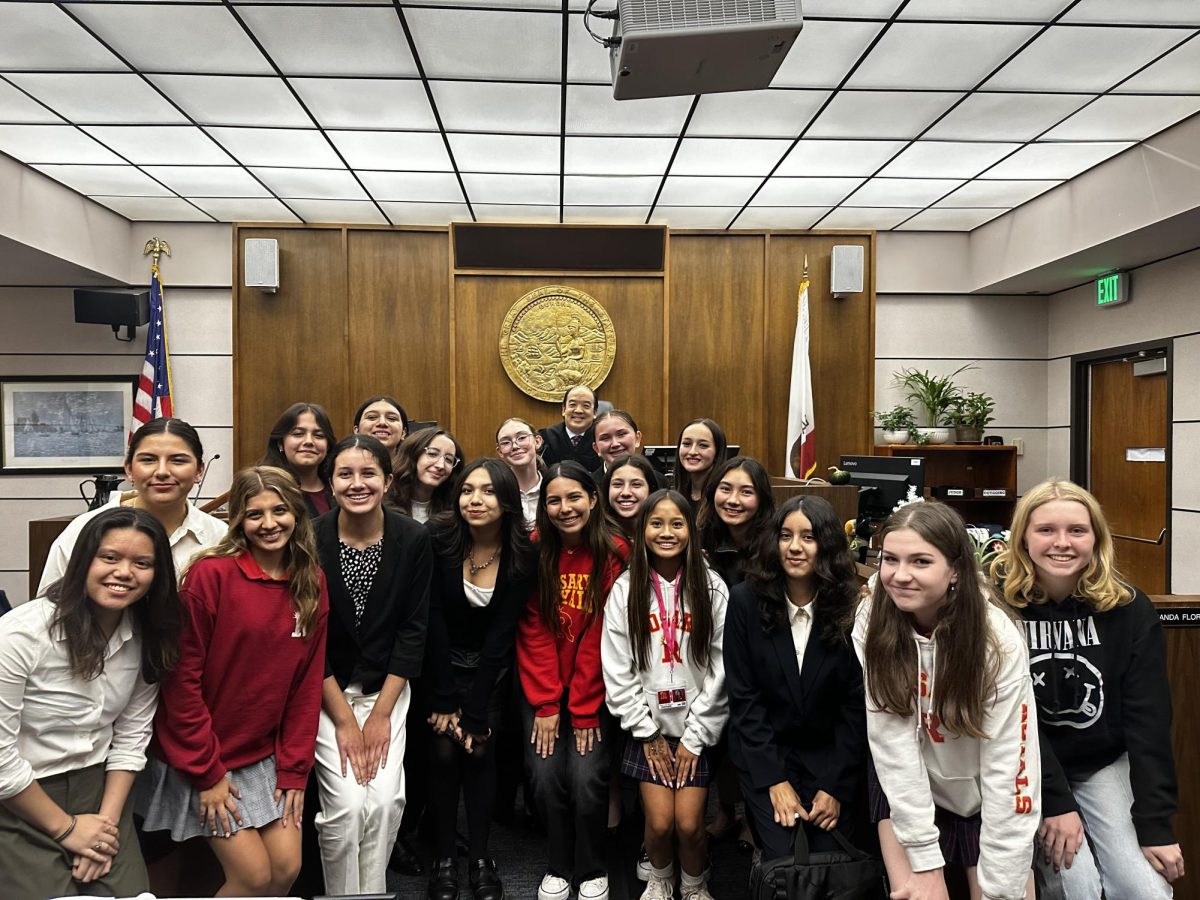 Rosary's winning Mock Trial team posed with the judge.