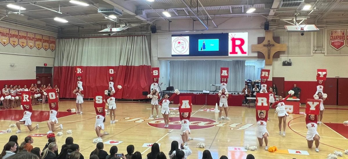 The Rosary Cheer team performs their game day routine to get the crowd rowdy. 