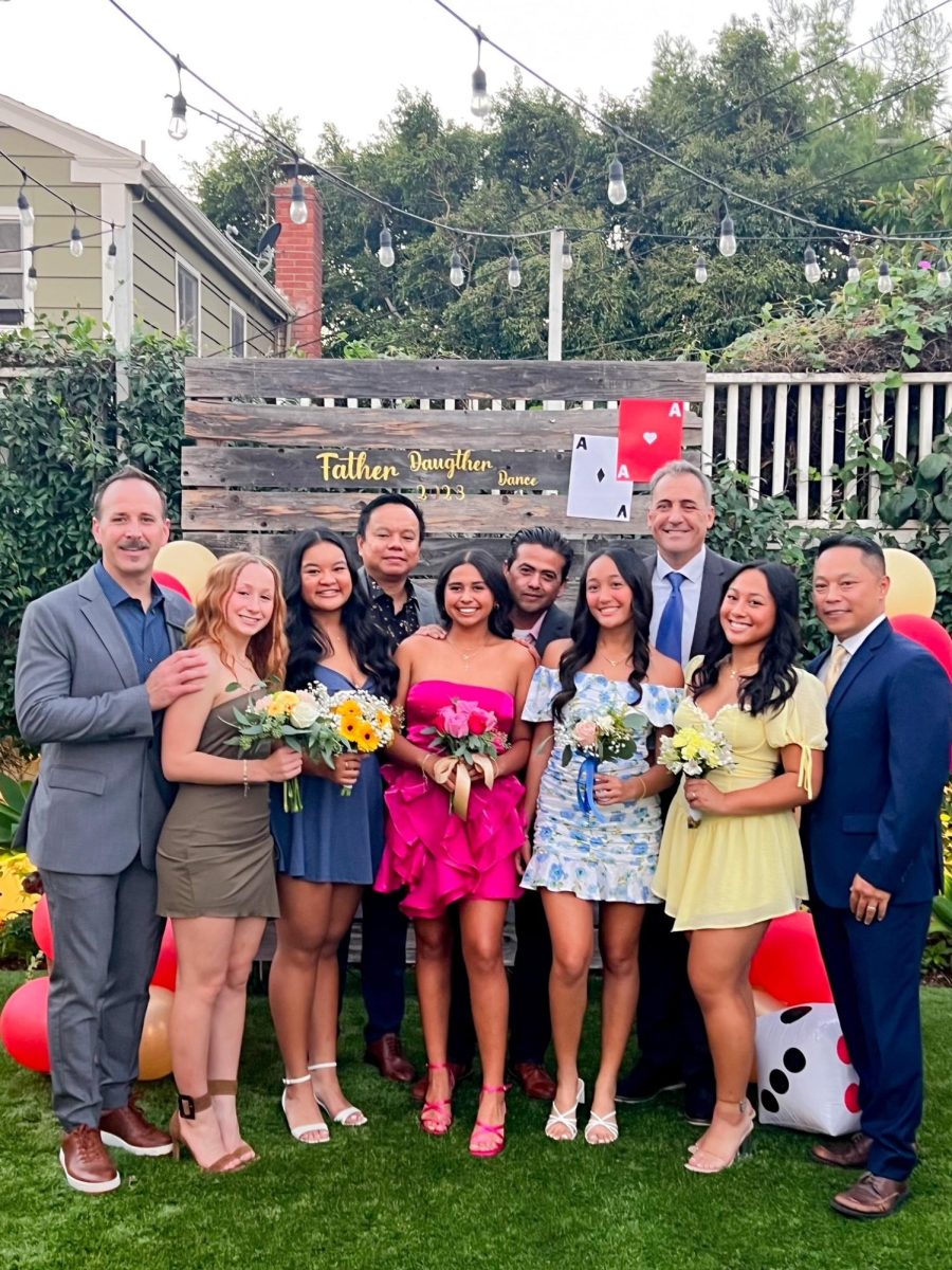 Juniors and their dads pose for a group picture before heading off to the dance. 