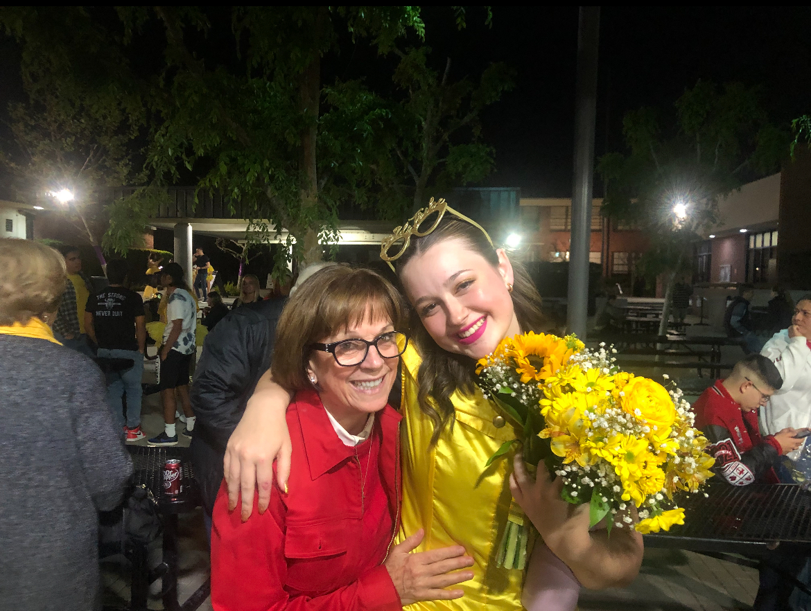 Mrs. Schults and Finley Hawkins '24 smile for a picture after a Red and Gold performance. 