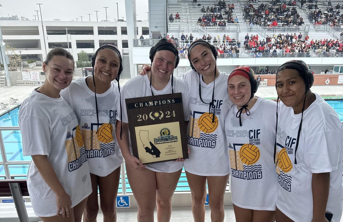 Returning players smile to the camera as they proudly hold their award.