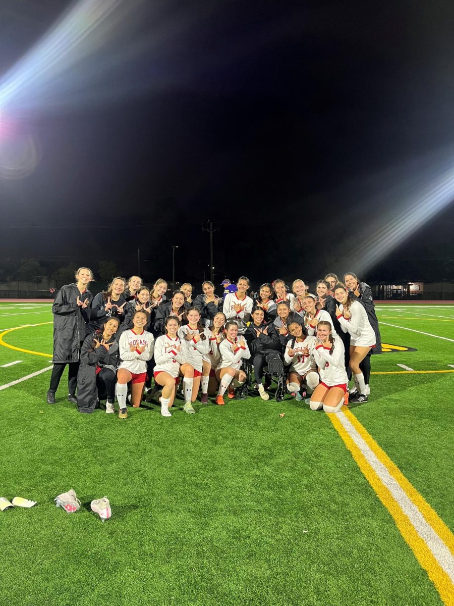 The varsity soccer team takes one final picture after their last Trinity League game.