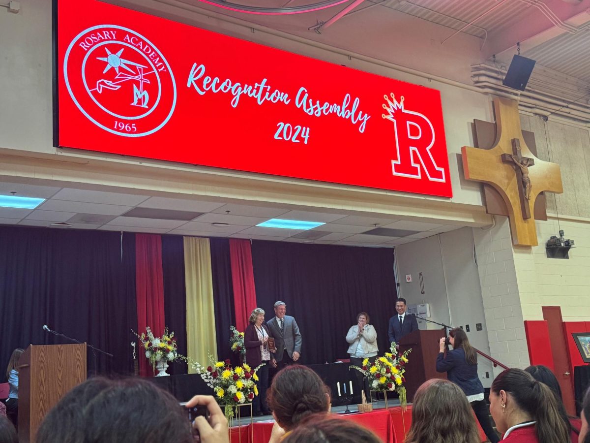 All the students cheered loudly as Ms. Ray accepts her Teacher of the Year award. 