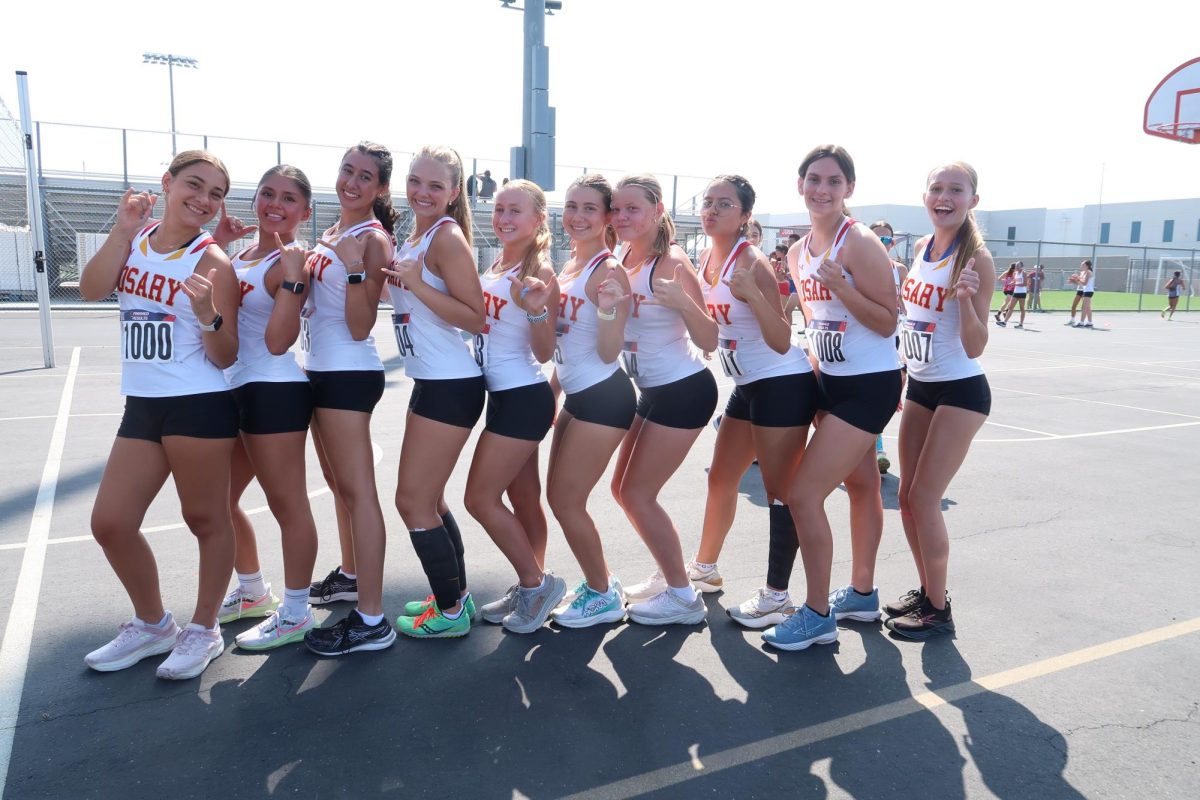 Harper Clark and Andrea Salazar with teammates at cross country meet (photo provided by Harper Clark)