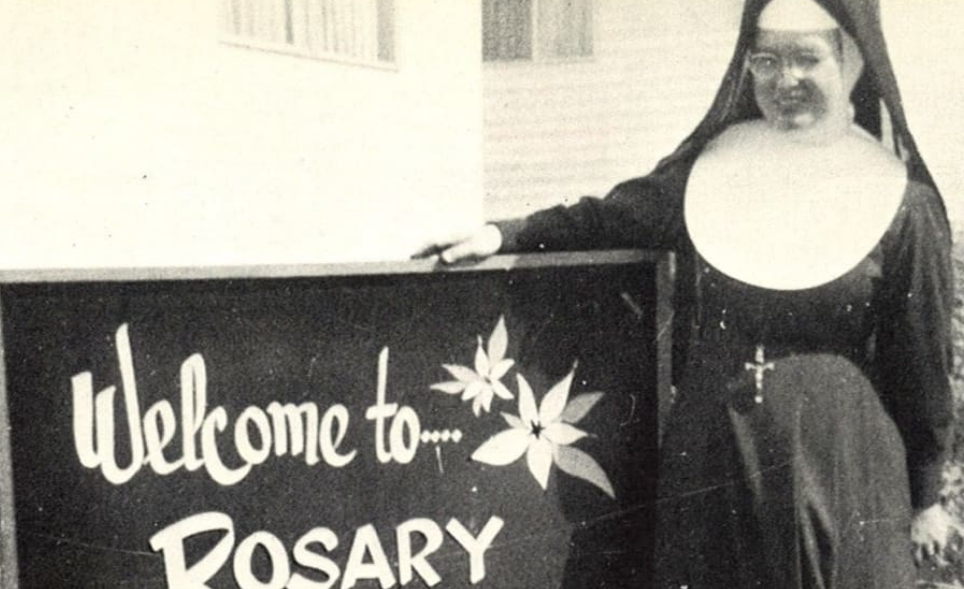 Here is one of the Sisters of Orange posing next to the very first Rosary sign. 