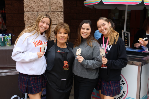 Julia Watson '24, Michaela Watson '26, Ms. AnneMarie Maciel '14 pose with their grandma and some ice cream.