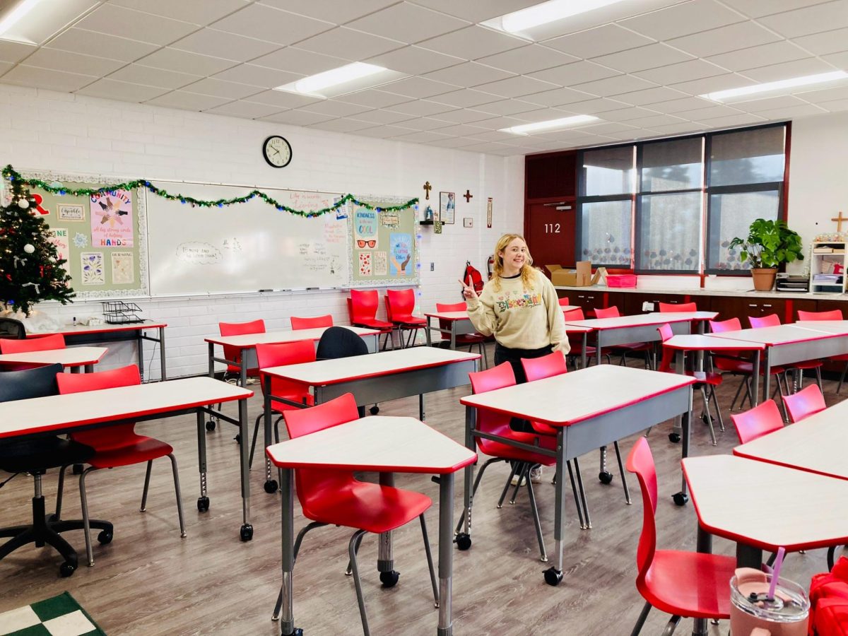 Ms. Mangold strikes a pose in her Christmas classroom.