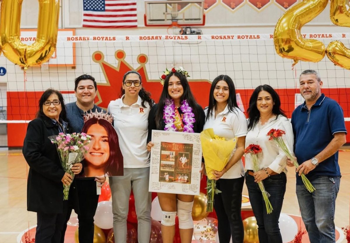 Chelsea posing with her family at her senior night.