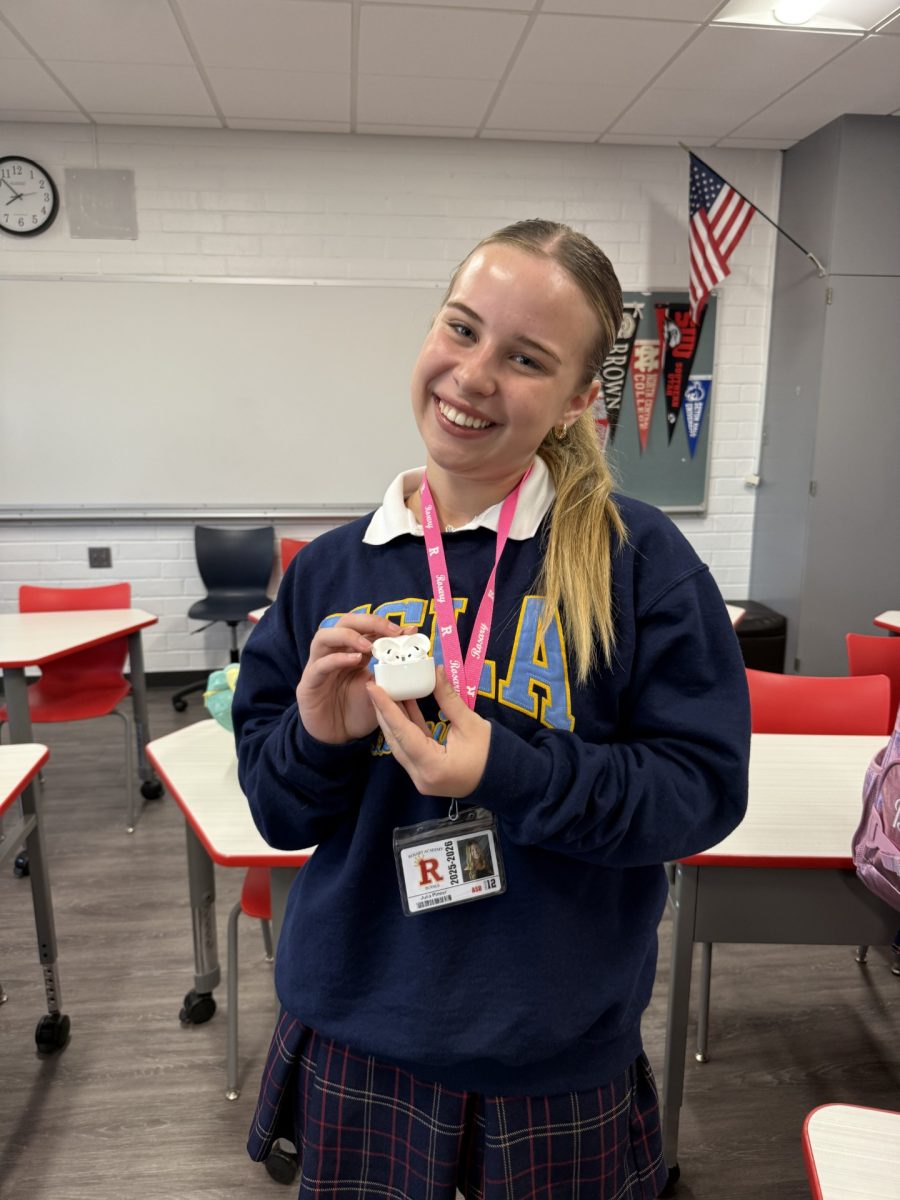 Here's Julia Pinner '26, with a pair of AirPods, reminding you to listen to some new music today.